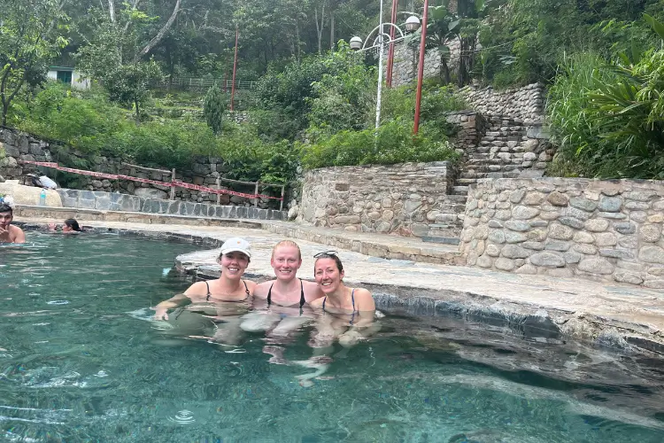 Travelers relaxing in the Cocalmayo hot springs during the Salkantay Trek 5 Days to Machu Picchu