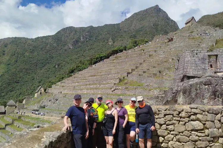 Travelers exploring and enjoying the panoramic views of Machu Picchu in Peru